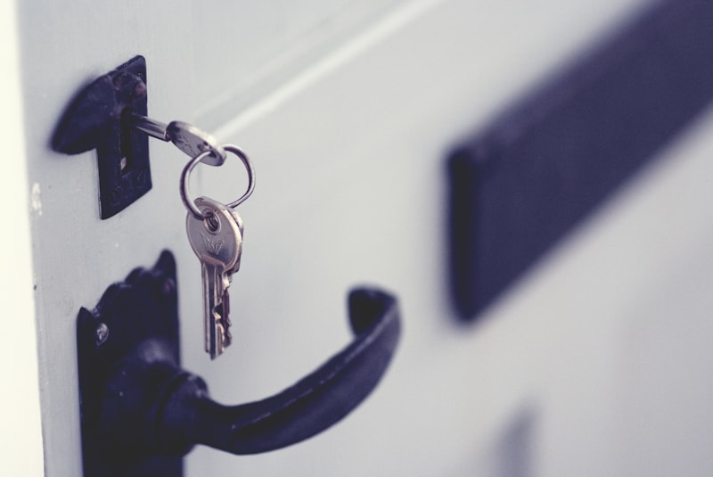 Black padlock securing a door, representing a home lockout situation