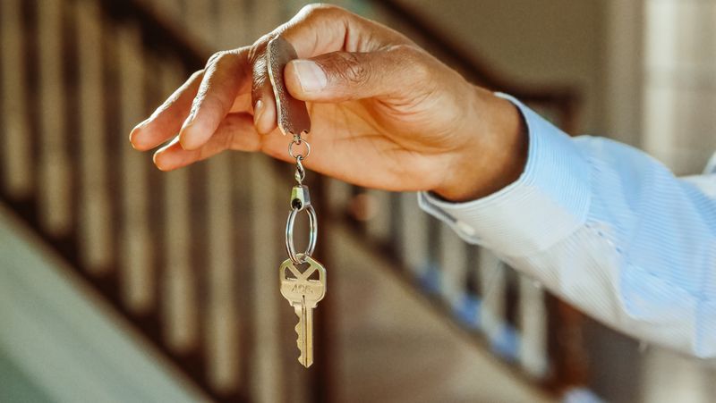 Property manager holding house keys for a rental property
